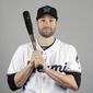 Neil Walker of the Miami Marlins baseball team poses Wednesday, Feb. 20, 2019, in Jupiter, Fla. While Manny Machado agreed to a pending $300 million, 10-year contract with San Diego and Bryce Harper is likely to top Giancarlo Stanton&#39;s record $325 million, 13-year deal, many less-than-superstar veterans have been routed on the free-agent market. Walker&#39;s salary dropped from $17.2 million to $2 million in two years. (AP Photo/Jeff Roberson)