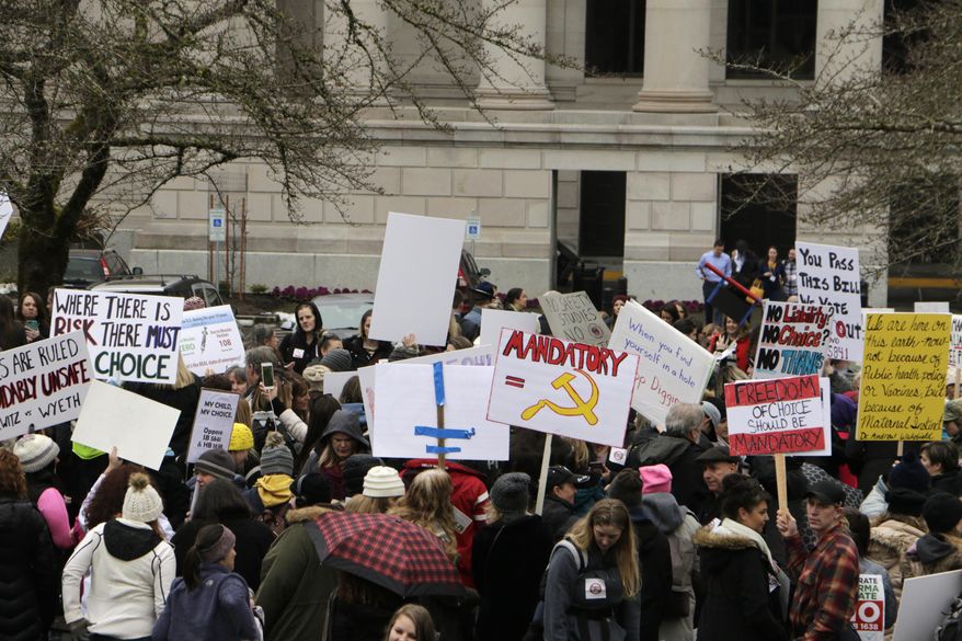 Opponents to efforts to remove philosophical exemptions from school-vaccine requirements rally outside the Washington Capitol, in Olympia, Wash., Wednesday, Feb. 20,2019. Lawmakers are considering two measures, one that would remove the exemption from the combined measles, mumps and rubella vaccine, and another that would not allow personal or philosophical exemptions to be granted for any required school vaccinations. (AP Photo/Rachel La Corte)