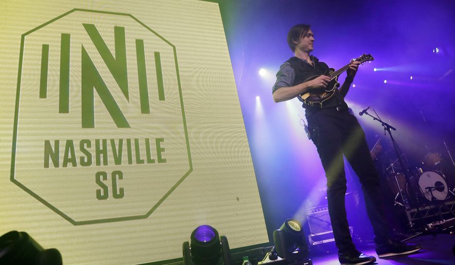 A band performs as the logo of the Nashville Soccer Club is displayed at the unveiling of the MLS team&#39;s name, logo and colors Wednesday, Feb. 20, 2019, in Nashville, Tenn. The expansion franchise is due to start play in 2020. (AP Photo/Mark Humphrey)