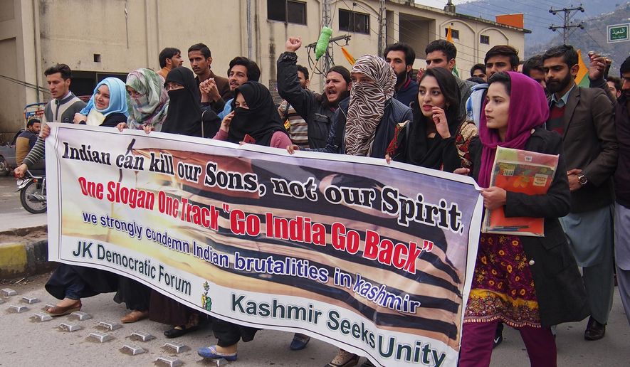 Kashmiri students rally against the Indian government in Muzaffarabad, capital of Pakistani Kashmir, Wednesday, Feb. 20, 2019. India has halted a key bus service with the Pakistani-controlled part of Kashmir, severing the only land route linking the divided Himalayan region. Pakistani official Shahid Mehmood said on Wednesday that New Delhi suspended the bus service this week without explanation. (AP Photo/M.D. Mughal)