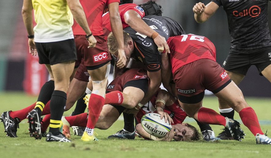 Hayden Parker of the Sunwolves gets tackled by Tyler Paul of the Sharks during the Super Rugby match between the Sunwolves and the Sharks at Singapore National Stadium, in Singapore, Saturday, Feb. 16, 2019. (AP Photo/Danial Hakim)