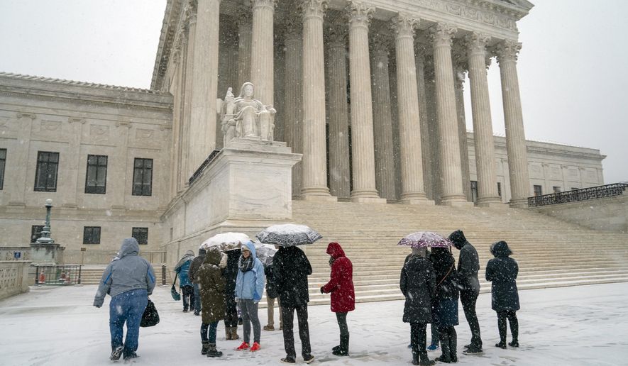 Visitors wait to enter the Supreme Court as a winter snowstorm hits the nation's capital making roads perilous and closing most federal offices and all major public school districts, on Capitol Hill in Washington, Wednesday, Feb. 20, 2019. The Supreme Court is ruling unanimously that the Constitution's ban on excessive fines applies to the states. The outcome Wednesday could help an Indiana man recover the $40,000 Land Rover police seized when they arrested him for selling about $400 worth of heroin. (AP Photo/J. Scott Applewhite)