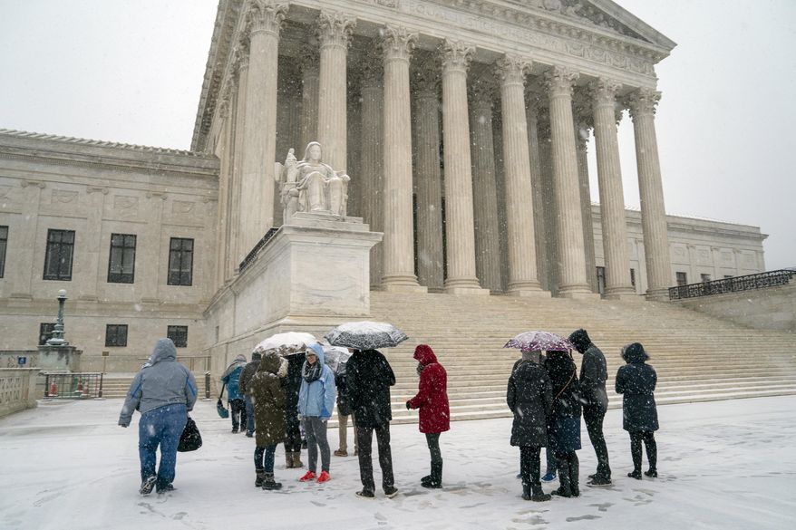 Visitors wait to enter the Supreme Court as a winter snowstorm hits the nation's capital making roads perilous and closing most federal offices and all major public school districts, on Capitol Hill in Washington, Wednesday, Feb. 20, 2019. The Supreme Court is ruling unanimously that the Constitution's ban on excessive fines applies to the states. The outcome Wednesday could help an Indiana man recover the $40,000 Land Rover police seized when they arrested him for selling about $400 worth of heroin. (AP Photo/J. Scott Applewhite)