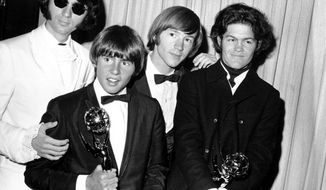 This June 4, 1967, file photo shows, from left, Mike Nesmith, Davy Jones, Peter Tork, and Micky Dolenz of The Monkees posing with their Emmy award for best comedy series at the 19th Annual Primetime Emmy Awards in Los Angeles.  Tork, who rocketed to teen idol fame in 1965 playing the lovably clueless bass guitarist in the made-for-television rock band The Monkees, died Thursday, Feb. 21, 2019, of complications related to cancer, according to his son Ivan Iannoli. He was 77.  (AP Photo, File)