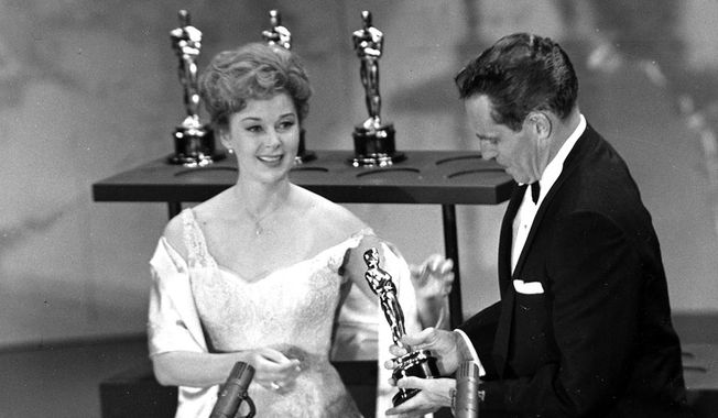 Susan Hayward presents an Oscar to Charlton Heston, during the annual Academy Awards show in Hollywood, Calif., on April 4, 1960. Heston was awarded best actor for his role in &quot;Ben-Hur.&quot;  (AP Photo )