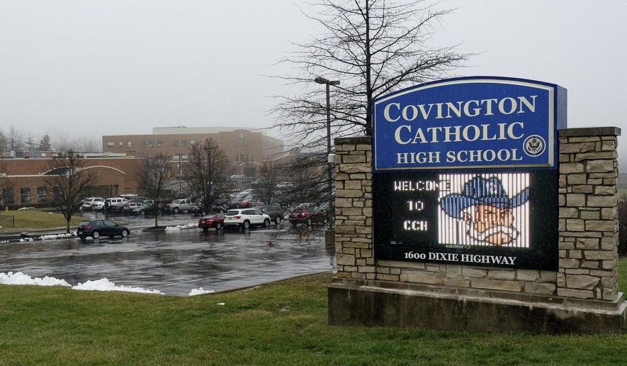 FILE - This Jan. 19, 2019 file photo shows an exterior view of Covington Catholic High School in Park Hills, Ky. Nicholas Sandmann, the Covington Catholic High School teen at the heart of an encounter last month with a Native American activist, is suing The Washington Post for $250 million. He is also threatening legal action against The Associated Press and other news organizations. In papers filed Tuesday in federal court in Kentucky, Nicholas Sandmann and his parents alleged that the Post had engaged in “targeting and bullying” and modern “McCarthyism.” (AP Photo/Bryan Woolston, File)