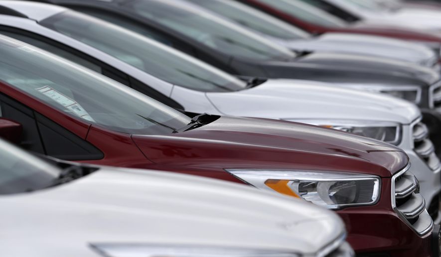 FILE- In this Sunday, Feb. 17, 2019, file photo an unsold 2019 Escape sports-utility vehicles sit in a long row at a Ford dealership in Broomfield, Colo. On Thursday, Feb. 21, the Commerce Department releases its December report on durable goods. (AP Photo/David Zalubowski, File)