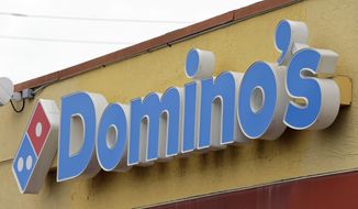 FILE - This Thursday, Oct. 27, 2016, photo shows a Domino&#39;s Pizza sign at a location in Hialeah, Fla.   Domino&#39;s Pizza Inc. on Thursday, Feb. 21, 2019  reported fourth-quarter earnings of $111.6 million. On a per-share basis, the Ann Arbor, Michigan-based company said it had net income of $2.62.(AP Photo/Alan Diaz, File)