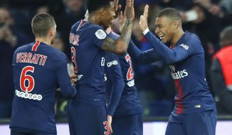 PSG&#39;s Kylian Mbappe celebrates with his teammates after scoring his side&#39;s fifth goal during the French League One soccer match between Paris Saint Germain and Montpellier at the Parc des Princes stadium in Paris, France, Wednesday, Feb. 20, 2019. (AP Photo/Francois Mori)