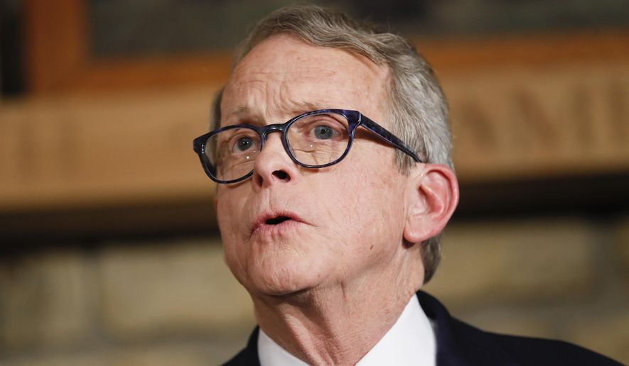 In this Jan. 14, 2019 file photo Mike DeWine speaks before being sworn-in as the 70th Governor of Ohio alongside his wife Fran, center right in Cedarville, Ohio. DeWine's administration on Thursday, Feb. 21, 2019 recommended increasing the state gas tax by 18 cents a gallon beginning July 1 and annually adjusting that tax for inflation to provide sufficient funding for maintenance of roads and bridges. (AP Photo/John Minchillo, Pool, file)