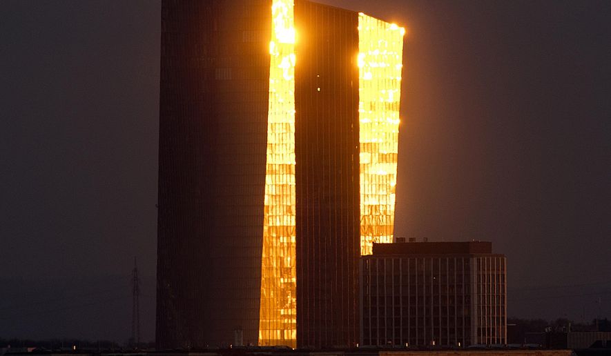 The last sunlight is reflected in the facade of the European Central Bank as the sun sets in Frankfurt, Germany, Tuesday, Feb. 19, 2019. (AP Photo/Michael Probst)