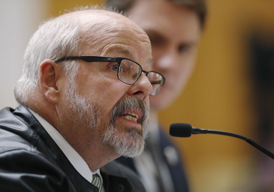 Colorado Rep. Tom Sullivan, D-Aurora, foreground, speaks as Colorado House Majority Leader Alec Garnett, D-Denver, listens during a hearing before the House Judiciary Committee on a bill to get a "red flag" gun law on the books in Colorado Thursday, Feb. 21, 2019, in Denver. The bill, which is backed by several law enforcement officials, would allow for the seizure of weapons from persons deemed by a court to pose a significant risk to themselves and to others. (AP Photo/David Zalubowski)