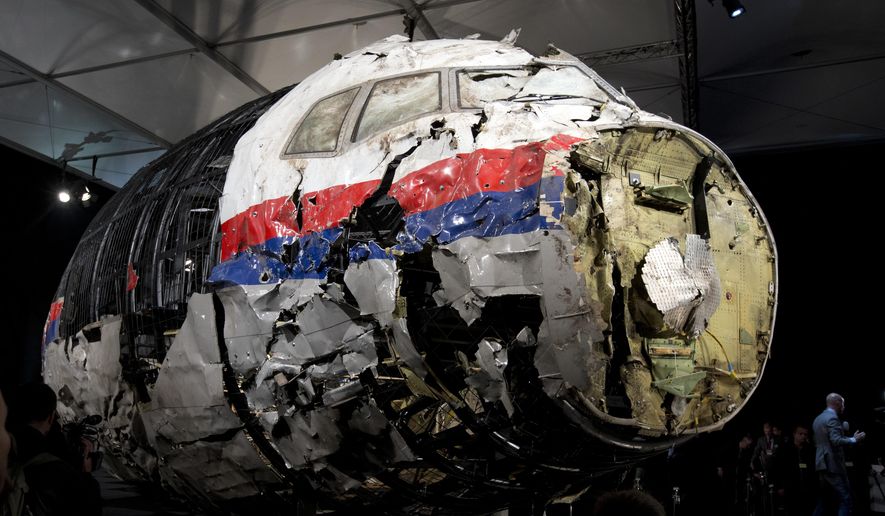 This Tuesday, Oct. 13, 2015, file photo, shows the reconstructed wreckage of Malaysia Airlines Flight MH17, put on display during a press conference in Gilze-Rijen, central Netherlands. Malaysia Airlines Flight 17 broke up high over Eastern Ukraine killing all 298 people on board. A Dutch safety watchdog says airlines around the world need more and better information to make risk assessments about flying over conflict zones. The Dutch Safety Board issued a report Thursday, Feb. 21, 2019, following up on its publication in 2015 of a probe into the cause of the downing of Malaysia Airlines Flight 17 over war-ravaged eastern Ukraine on July 17, 2014. (AP Photo/Peter Dejong, File)