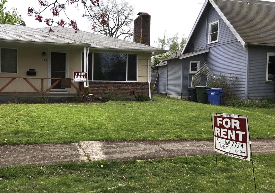 This April 22, 2017, file photo shows "For Rent" signs in front of a house in Salem, Ore. A committee of the Oregon House of Representatives debated a bill that would make Oregon the first state to impose mandatory rent controls statewide. The committee on Wednesday, Feb. 20, 2019, rejected proposed amendments that would make certain parts of the state exempt from the bill. (AP Photo/Andrew Selsky, File)