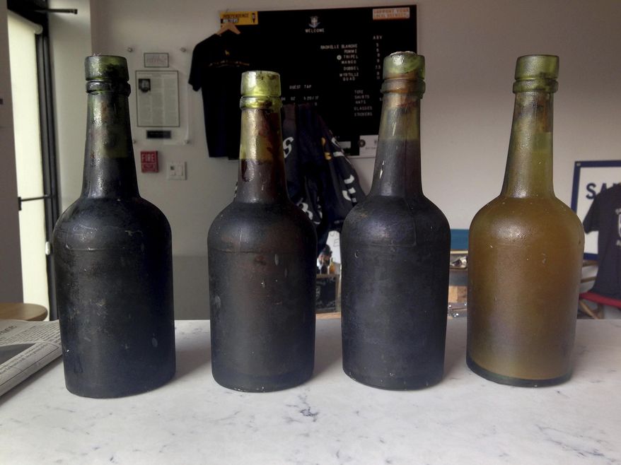 In this July 17, 2017 photo provided by Jamie Adams, four bottles recovered from the SS Oregon, a 133-year-old shipwreck, are shown at the Saint James Brewery in Holbrook, N.Y.  Bill Felter of Serious Brewing in Howes Cave, N.Y., hoped to develop a new brew from ale salvaged from the SS Oregon. But the scuba-diving Long Island brewer, Adams, has scuttled those plans, saying he owns the shipwreck yeast and has used it to produce ale he’s releasing in March 2019. (Jamie Adams via AP)