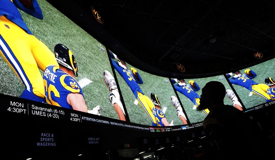 FILE - In this Feb. 3, 2019, file photo, a man watches Super Bowl LIII at the Westgate Superbook sports book in Las Vegas. Kentucky's public employee pension system, $39 billion in the red, is among the worst-funded retirement plans in the country and has vexed lawmakers for years as they sought a solution. Now some lawmakers think they’ve found at least a partial fix: sports gambling. (AP Photo/John Locher, File)