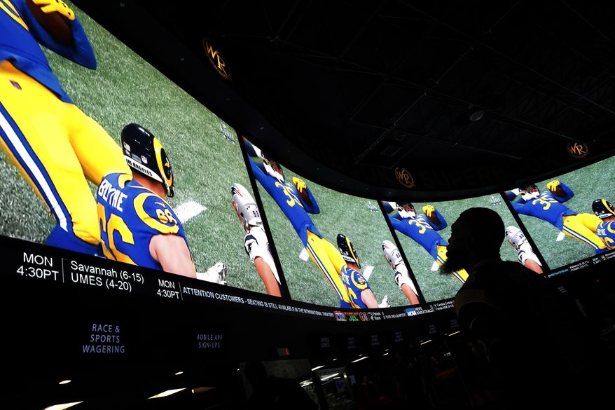 FILE - In this Feb. 3, 2019, file photo, a man watches Super Bowl LIII at the Westgate Superbook sports book in Las Vegas. Kentucky's public employee pension system, $39 billion in the red, is among the worst-funded retirement plans in the country and has vexed lawmakers for years as they sought a solution. Now some lawmakers think they’ve found at least a partial fix: sports gambling. (AP Photo/John Locher, File)