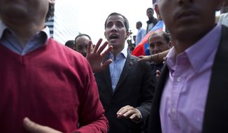 CORRECTS SPELLING OF GUAIDO - Venezuela&#39;s self-proclaimed interim president Juan Guaido walks into the crowd after he addressed transportation workers during a demonstration of support for him in Caracas, Venezuela, Wednesday, Feb. 20, 2019. Venezuela is gripped by a historic political and economic crisis despite having the world’s largest proven oil reserves. (AP Photo/Ariana Cubillos)