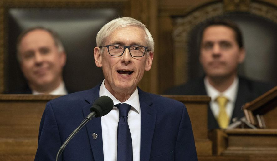 FILE- In this Jan. 22, 2019, file photo Wisconsin Gov. Tony Evers addresses a joint session of the Legislature in the Assembly chambers during the Governor's State of the State speech at the state Capitol in Madison, Wis. The Democratic Governor says a judge should suspend Republicans' lame duck law limiting his powers. Labor unions filed a lawsuit this month challenging the law, which prohibits Evers from pulling the state out of lawsuits without legislative approval and requires state agencies to take down publications explaining how they interpret state law by July unless they send the documents through a public comment period. (AP Photo/Andy Manis, File)