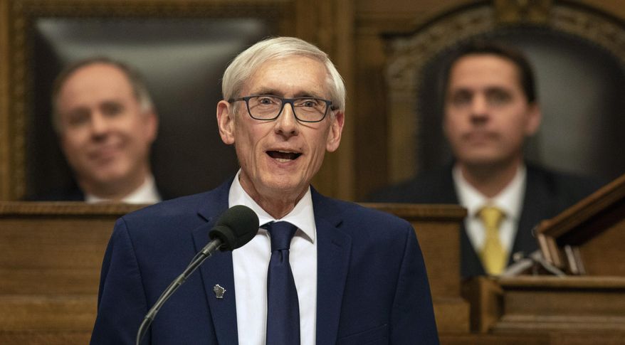 FILE- In this Jan. 22, 2019, file photo Wisconsin Gov. Tony Evers addresses a joint session of the Legislature in the Assembly chambers during the Governor's State of the State speech at the state Capitol in Madison, Wis. The Democratic Governor says a judge should suspend Republicans' lame duck law limiting his powers. Labor unions filed a lawsuit this month challenging the law, which prohibits Evers from pulling the state out of lawsuits without legislative approval and requires state agencies to take down publications explaining how they interpret state law by July unless they send the documents through a public comment period. (AP Photo/Andy Manis, File)
