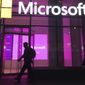 In this Nov. 10, 2016, file photo, people walk near a Microsoft office in New York. A group of Microsoft workers is demanding the company cancel a contract supplying U.S. Army soldiers with HoloLens headsets that could help them spot adversaries on the battlefield. A letter signed by more than 50 employees Friday, Feb. 22, 2019, says they &quot;refuse to create technology for warfare and oppression.&quot; (AP Photo/Swayne B. Hall, File)