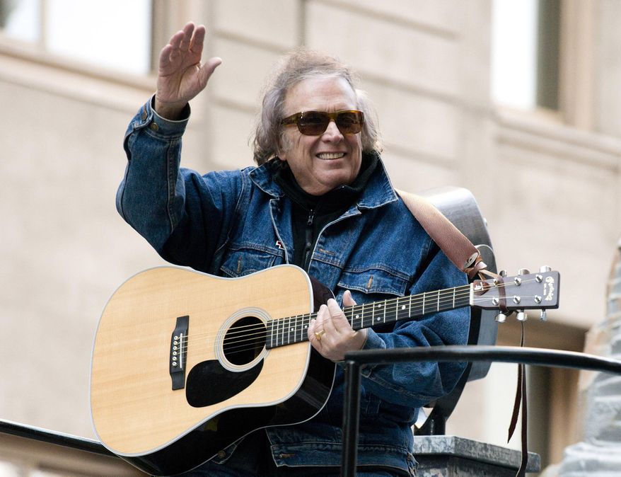 FILE - In this Nov. 22, 2012 file photo, Don McLean rides a float in the Macy's Thanksgiving Day Parade in New York. Don McLean has threatened to sue a weekly newspaper that wrote about his former wife's photo exhibition about domestic abuse, which includes a copy of the protection order issued against him., Friday, Feb. 22, 2019. (AP Photo/Charles Sykes, File)