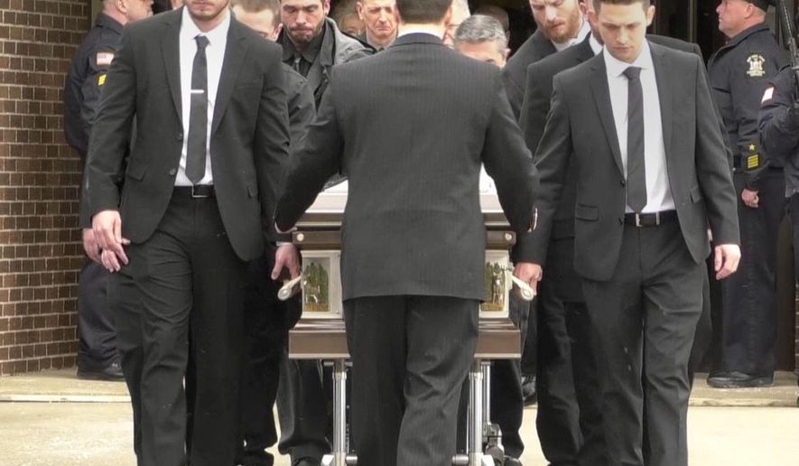 In this image taken from video provided by WWNY TV in Watertown, N.Y., pallbearers bring a casket with a Bodah family member toward an awaiting hearse at Our Lady of the Sacred Heart church in Watertown, N.Y., Friday, Feb. 22, 2019. Five members of the Bodah family died in a house fire in the early hours of Valentine's Day, Thursday, Feb. 14, 2019. Investigators said it appeared the fire started in the kitchen where pots were left on the electric stove. (WWNY TV via AP)