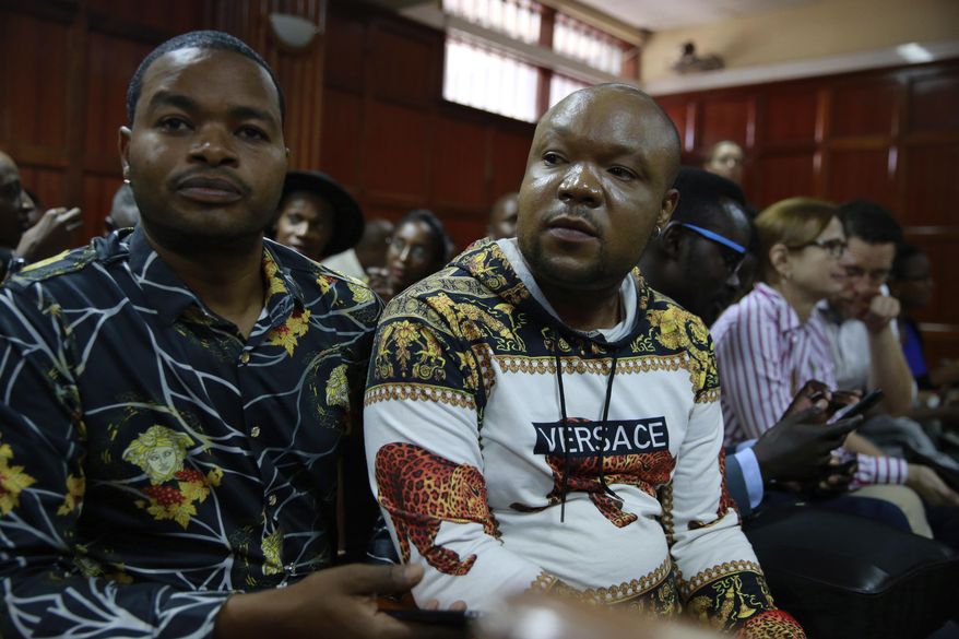 LGBT supporters wait at the Milimani court for the Kenyan court ruling on whether to decriminalize same sex relationships, in Nairobi, Kenya, Friday, Feb. 22, 2019. A Kenyan judge says the High Court has postponed a ruling on a petition to decriminalize same sex relationships. The decision has left the tens of the activists who turned up in court disappointed. (AP Photo/Brian Inganga) .