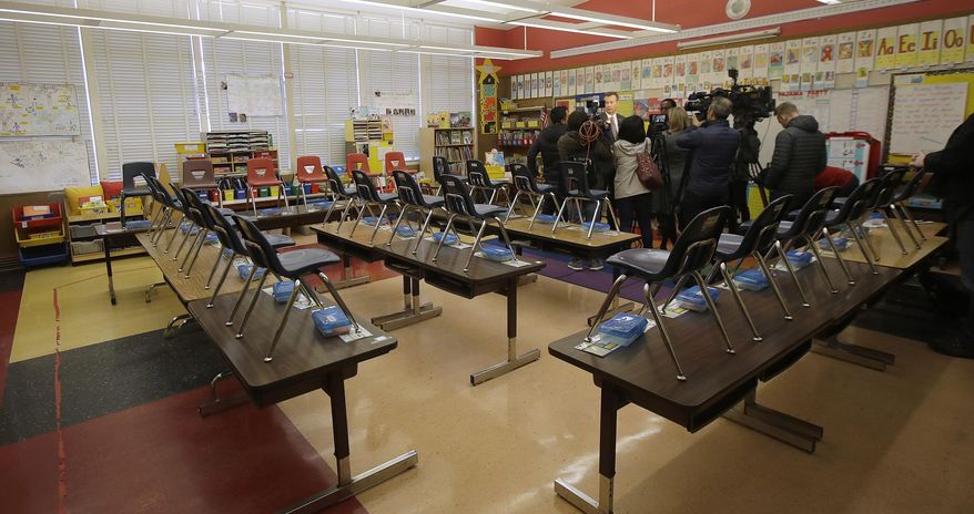 John Sasaki, communications director with Oakland Unified School District, speaks to reporters in an empty classroom at Manzanita Community School in Oakland, Calif., Thursday, Feb. 21, 2019. Teachers in Oakland, California, went on strike in the country's latest walkout by educators over classroom conditions and pay. (AP Photo/Jeff Chiu) ** FILE **