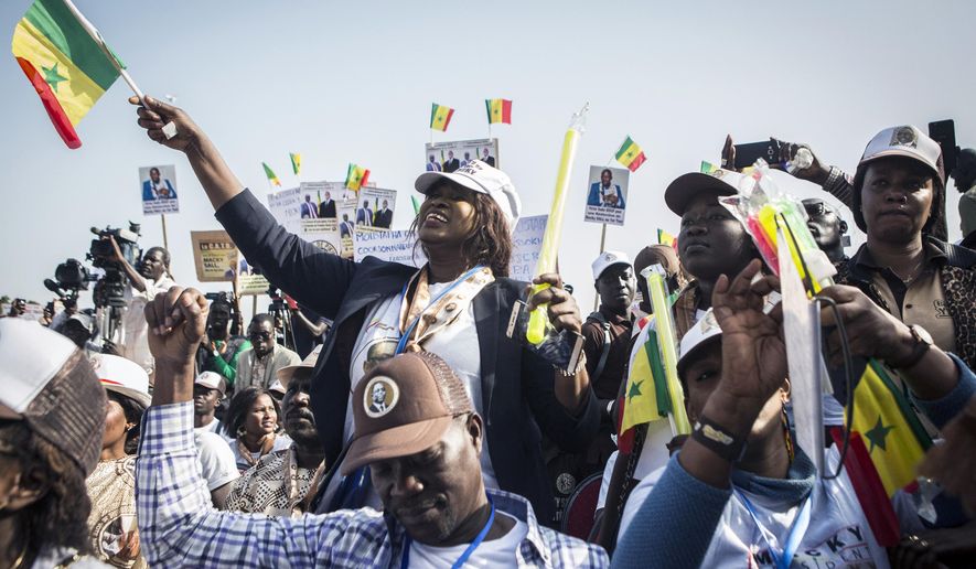 In this photo taken on Thursday, Feb. 21, 2019, supporters of Senegalese President Macky Sall cheer as he speaks at a rally ahead of Sunday&#x27;s presidential elections in Dakar, Senegal.  Sall is seeking a second term in office and hopes to win re-election Sunday in the first round. (AP Photo/Jane Hahn)