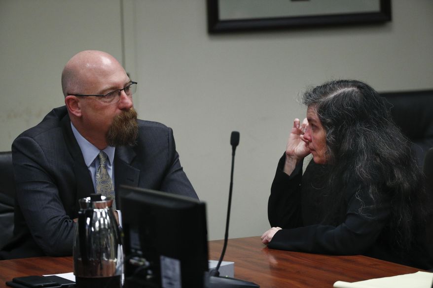 Louise Turpin wipes away her tears while talking to her attorney, Jeff Moore, in a courtroom Friday, Feb. 22, 2019, in Riverside, Calif. Turpin and her husband, David, who shackled some of their 13 children to beds and starved them pleaded guilty on Friday to torture and other abuse. (AP Photo/Jae C. Hong, Pool)