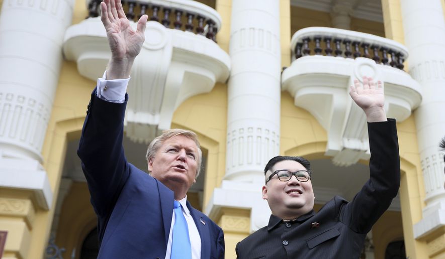 U.S. President Donald Trump impersonator Russell White, left, and Kim Jong-un impersonator Howard X pose for photos outside the Opera House in Hanoi, Vietnam, Friday, Feb. 22, 2019. The second summit between Trump and Kim will take place in Hanoi on Feb. 27 and 28. (AP Photo/Minh Hoang)