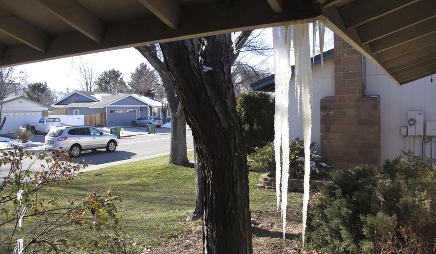 A car passes a house Friday afternoon, Feb. 22, 2019, in Sparks, Nev. where most of the snow has melted but a bitter cold front continued to push unseasonably cold temperatures across the region. The low temperature in northeast Nevada fell to minus 19 early Friday near Elko in the mountains around Lamoille and minus 8 in the Sierra at South Lake Tahoe, California. (AP Photo/Scott Sonner)