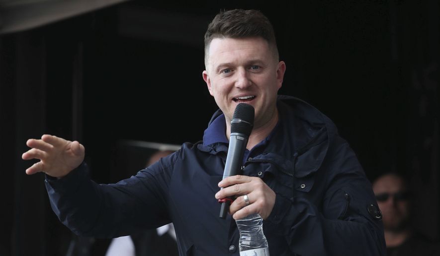 Former leader and founder of the English Defence League, Tommy Robinson addresses an EDL protest over a TV program, outside the BBC building in Salford, England, Saturday Feb. 23, 2019.  The EDL is a far-right nationalist social movement aiming to restrict immigration. (Danny Lawson/PA via AP)   ** FILE **