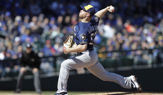 Milwaukee Brewers&#39; Chase Anderson throws during the first inning of a spring training baseball game against the Chicago Cubs, Saturday, Feb. 23, 2019, in Mesa, Ariz. (AP Photo/Darron Cummings)