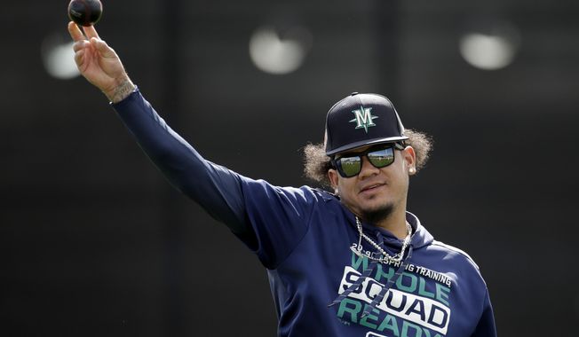 Seattle Mariners pitcher Felix Hernandez throws during spring training baseball practice Saturday, Feb. 16, 2019, in Peoria, Ariz. (AP Photo/Charlie Riedel)