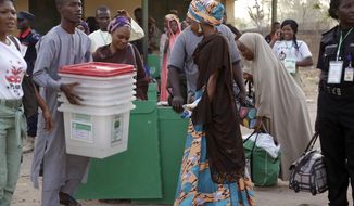 Electoral officials carry ballot boxes before the Presidential and National Assembly election in Yola, Nigeria, Saturday, Feb. 23, 2019. Africa&#39;s most populous country goes to the polls on Saturday to decide whether President Muhammadu Buhari deserves a second term. While more than 70 people are running to lead Nigeria, the close race comes down to Buhari and a billionaire former vice president, Atiku Abubakar. (AP Photo/Sunday Alamba)