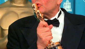 FILE - In this March 23, 1998 file photo, director Stanley Donen kisses the Oscar he received for Lifetime Achievement backstage at the 70th Academy Awards at the Shrine Auditorium in Los Angeles. Donen, whose &amp;quot;Singin&#39; in the Rain&amp;quot; provided some of the most unforgettable moments in movie history, has died, on Thursday, Feb. 21, 2019 in New York.  (AP Photo/Reed Saxon, File)