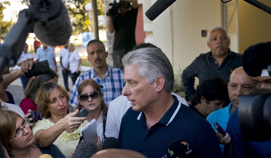 Cuba's President Miguel Diaz-Canel talks to the press after voting in a referendum to approve or reject the new constitution in Havana, Cuba, Sunday, Feb. 24, 2019. The constitutional reforms maintain Cuba's single-party political system and centrally planned economy while recognizing private property and small businesses, which have been part of the island's economy without formal legal status for more than a decade. (AP Photo/Ramon Espinosa)