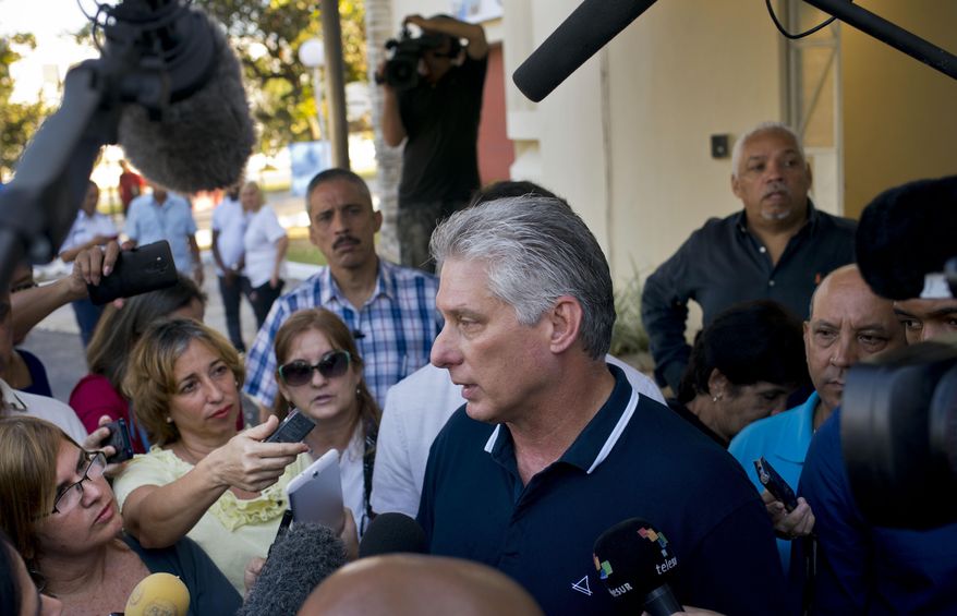 Cuba's President Miguel Diaz-Canel talks to the press after voting in a referendum to approve or reject the new constitution in Havana, Cuba, Sunday, Feb. 24, 2019. The constitutional reforms maintain Cuba's single-party political system and centrally planned economy while recognizing private property and small businesses, which have been part of the island's economy without formal legal status for more than a decade. (AP Photo/Ramon Espinosa)