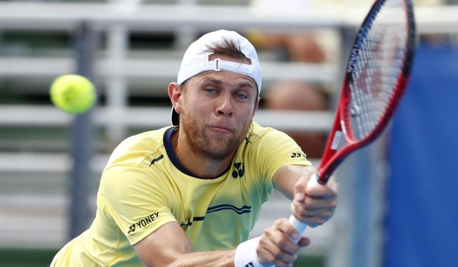 Radu Albot, of Moldova, returns a shot from Daniel Evans, of Britain, during the final tennis match at the Delray Beach Open, Sunday, Feb. 24, 2019 in Delray Beach, Fla. (AP Photo/Wilfredo Lee)