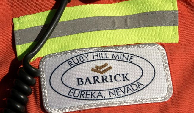 FILE - In this Feb. 14, 2006 file photo, a close-up of the chest patch of a worker at Barrick&#x27;s Ruby Hill Mine, outside Eureka, Nev., is shown. Barrick Gold will try to acquire Newmont Mining Corp. in an all-stock deal that would create a mining behemoth worth about $42 billion. Newmont, based in Colorado, has shunned the Canadian miner so far, and the latest overture could become hostile. Barrick President and CEO Mark Bristow said that the two companies have highly complementary assets in Nevada, which includes Barrick’s mineral endowments and Newmont’s processing plants and infrastructure.  (AP Photo/Douglas C. Pizac, File)