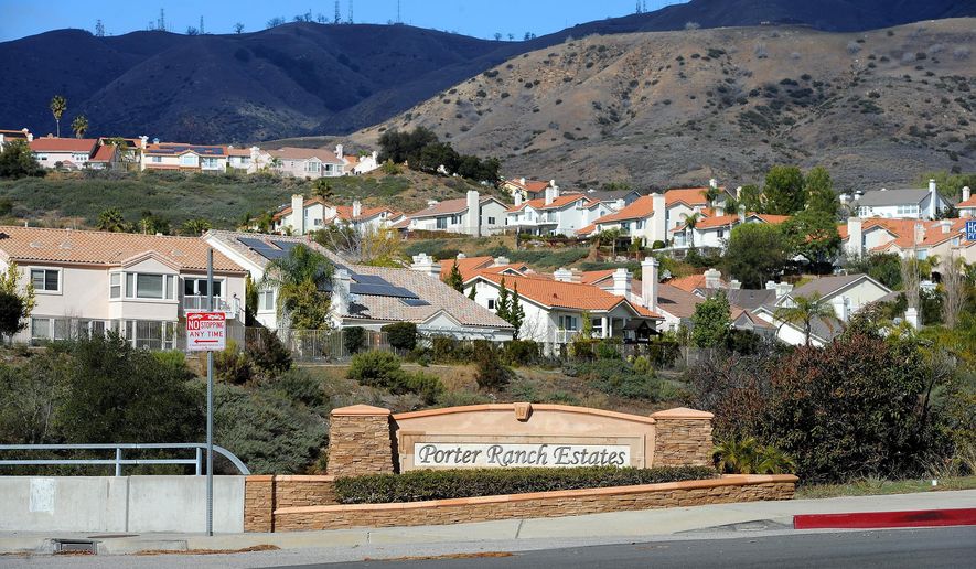 FILE - In this Jan. 7, 2016 file photo, Porter Ranch Estates sit at the foothills near a Southern California Gas Co. gas well that leaked methane daily near the community Porter Ranch, Calif. A stink is being raised over a $120 million court settlement from the nation's largest-known natural gas leak and it's not about money, but cow manure. Environmental groups have criticized a plan to put more than a fifth of the settlement toward capturing climate-changing methane from dairy farms in California's San Joaquin Valley. (AP Photo/Michael Owen Baker, File)