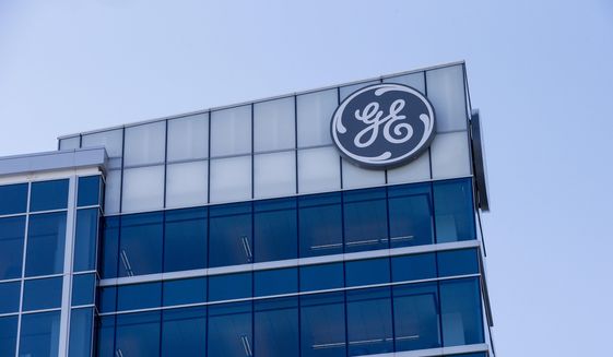 In this Jan. 16, 2018, photo, the General Electric logo is displayed at the top of their Global Operations Center in the Banks development of downtown Cincinnati. (AP Photo/John Minchillo) **FILE**