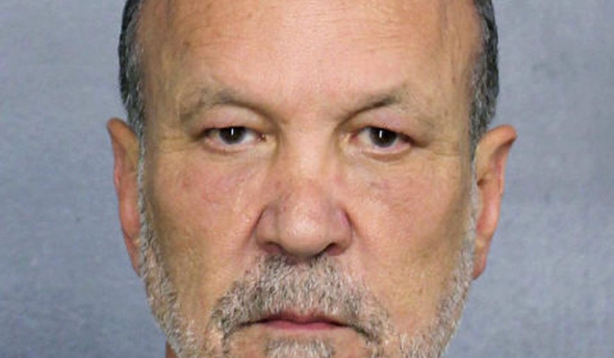 In this Feb. 24, 2019 photo made available by the Broward County Sheriff's Office, Fla., shows Ron Book under arrest. Book, a prominent lobbyist, is facing drunk-driving charges after an accident Sunday, Feb. 24, where property damage was recorded. (Broward County Sheriff's Office via AP)