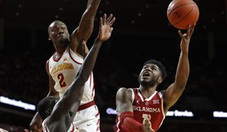 Oklahoma guard Rashard Odomes, right, shoots over Iowa State&#39;s Marial Shayok and Cameron Lard (2) during the first half of an NCAA college basketball game, Monday, Feb. 25, 2019, in Ames, Iowa. (AP Photo/Charlie Neibergall)