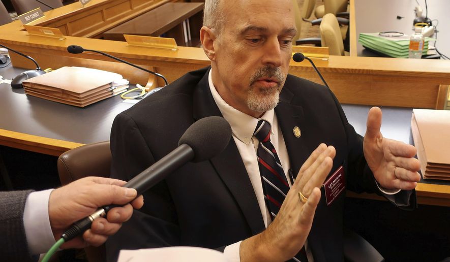 Kansas state Rep. Les Mason, R-McPherson, answers questions from reporters following the House Taxation Committee's approval of a tax relief bill, Monday, Feb. 25, 2019, at the Statehouse in Topeka, Kan. The committee has married GOP income tax relief proposals to a proposal to cut the state's sales tax on groceries. (AP Photo/John Hanna)