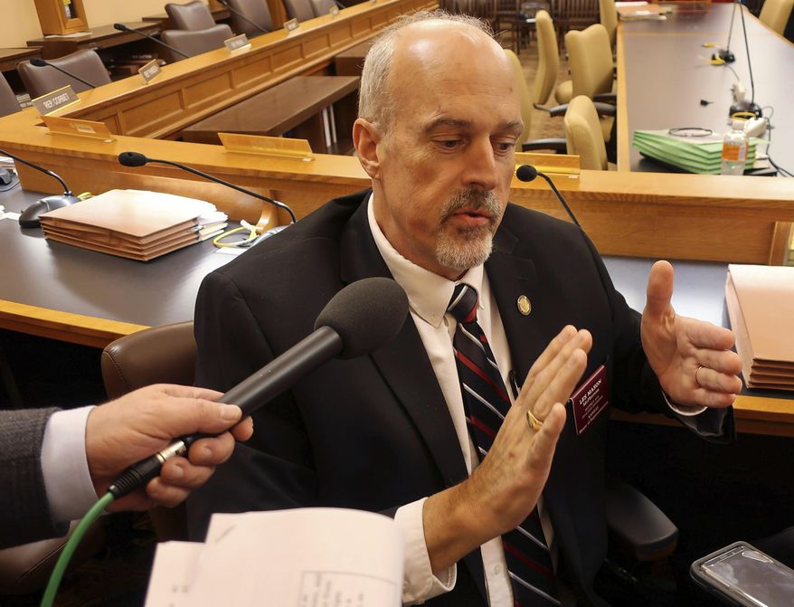 Kansas state Rep. Les Mason, R-McPherson, answers questions from reporters following the House Taxation Committee's approval of a tax relief bill, Monday, Feb. 25, 2019, at the Statehouse in Topeka, Kan. The committee has married GOP income tax relief proposals to a proposal to cut the state's sales tax on groceries. (AP Photo/John Hanna)