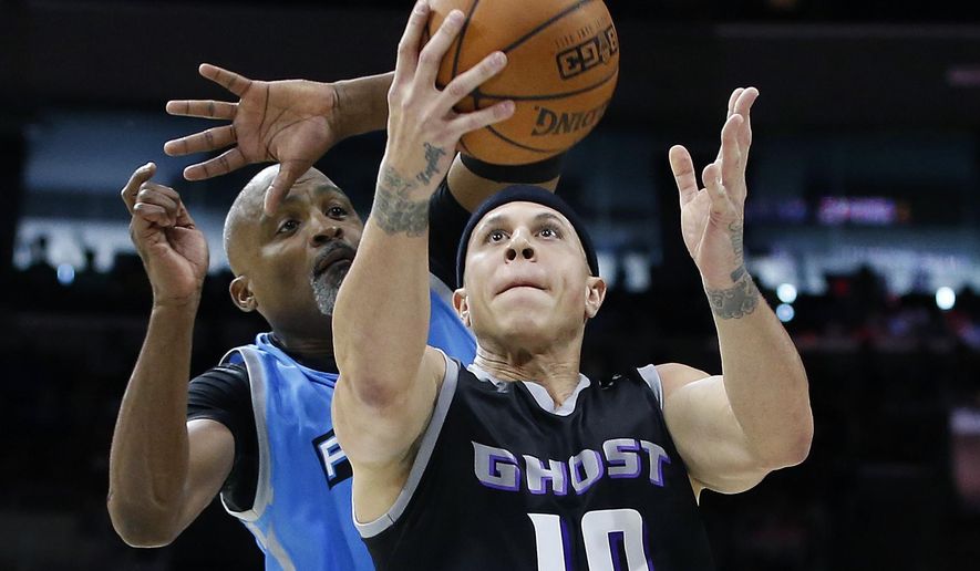 FILE - This is a July 16, 2017, file photo showing Ghost Ballers&#x27; Mike Bibby (10) attempting a shot as Power&#x27;s Cuttino Mobley defends during the first half of a BIG3 Basketball League game in Philadelphia. Officials in a suburban Phoenix school district say police are investigating sexual abuse and harassment accusations lodged against former NBA player Mike Bibby, who coaches a school basketball team. (AP Photo/Rich Schultz, File)