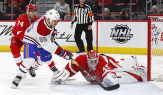 Montreal Canadiens right wing Andrew Shaw (65) scores on Detroit Red Wings goaltender Jonathan Bernier (45) in the third period of an NHL hockey game, Tuesday, Feb. 26, 2019, in Detroit. (AP Photo/Paul Sancya)